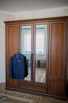Men's suit hanging on a hanger on a closet