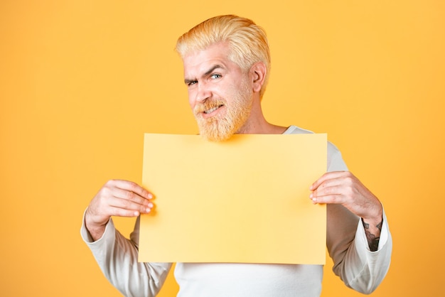 Men showing empty yellow board with copy space for advertisement