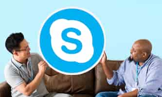 Free photo men showing a skype icon