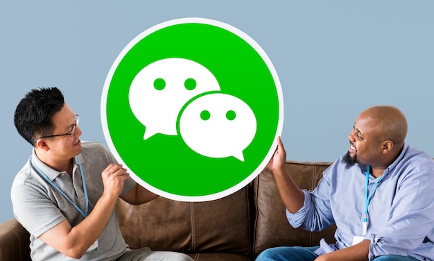 Men showing a WeChat icon