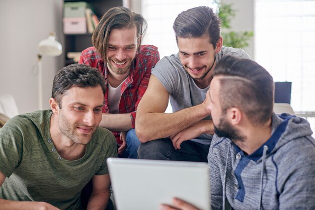 Men sitting in the living room and surfing the Internet