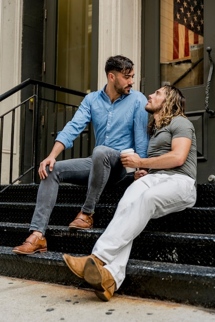 Men sitting on stairs and chatting