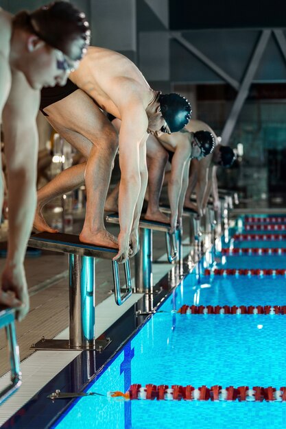 Men standing on starting blocks preparing