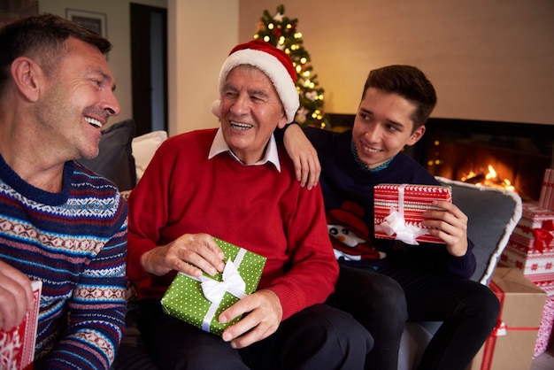 Men of three generations sitting on the sofa