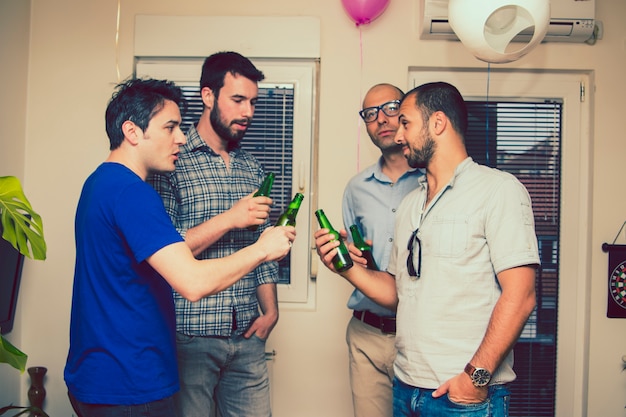 Men toasting with beer at the party