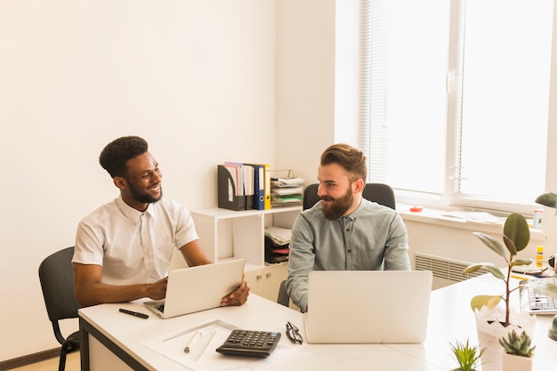 Men using laptops and chatting