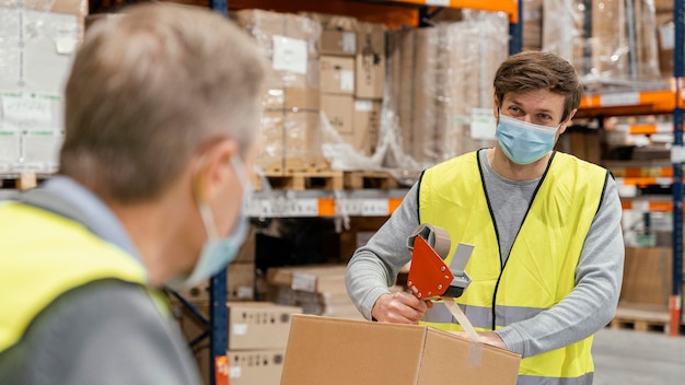 Free photo men in warehouse working