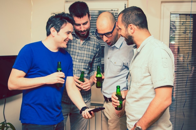 Men watching the smartphone at the party