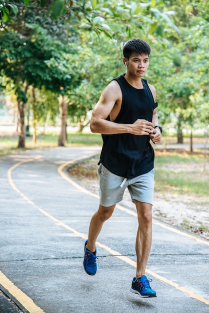 Free Photo | Men and women exercise by running on the road.