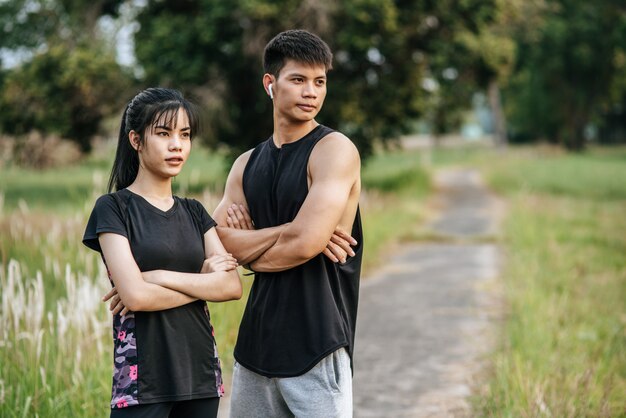 Men and women standing and cross arms exercise after.