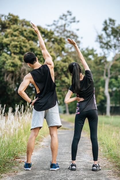 Men and women warm up before and after exercising.