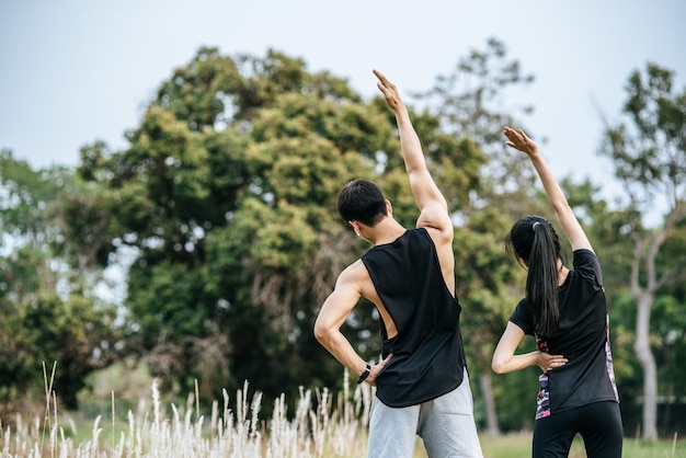 Men and women warm up before and after exercising.