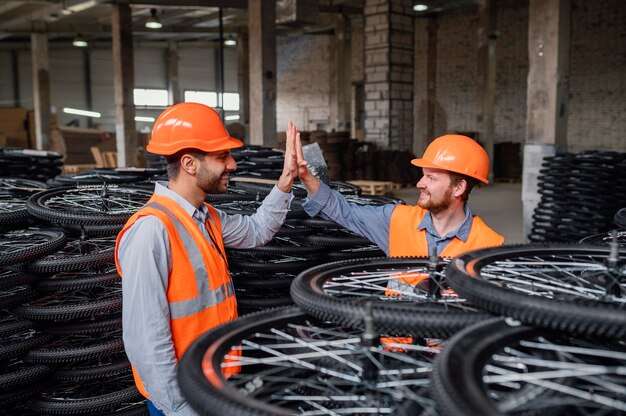 Men working next to a bunch of wheels