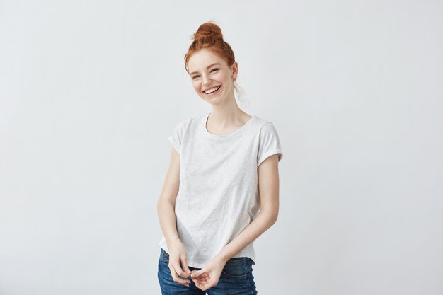 Merry beautiful redhead woman laughing.