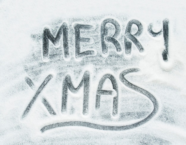 Merry Christmas inscription between decorative snow