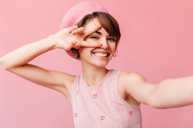 Merry french woman showing peace sign