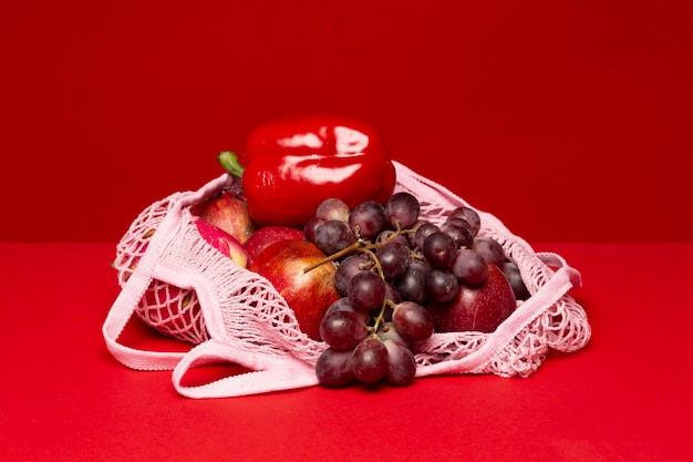 Mesh bag with apples and grapes