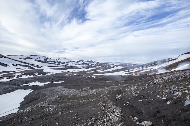 Mesmerizing scenery of snowy mountains  with cloudy sky