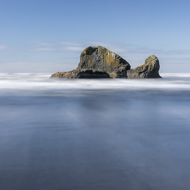 Mesmerizing shot of a huge rock with ocean