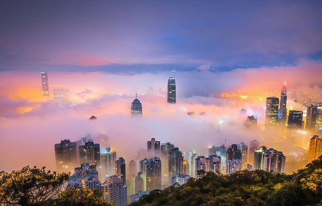 Mesmerizing shot of the skyscrapers of a city covered in mist at night