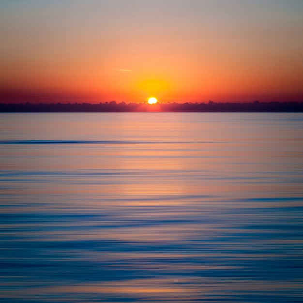 Mesmerizing sunset over the clear blue ocean