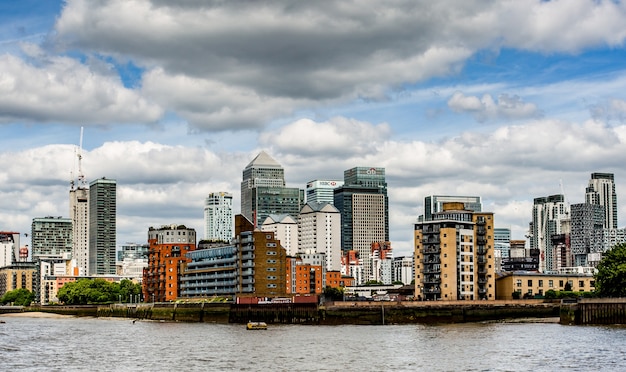 Mesmerizing view of a calm lake with beautiful buildings under a cloudy sky