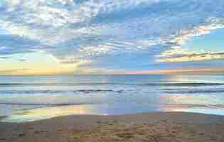 Free photo mesmerizing view of the ocean by the sandy coast