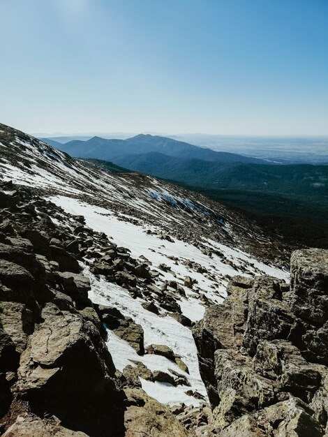 Mesmerizing view of the Penalara mountain in Spain covered in snow on a sunny day