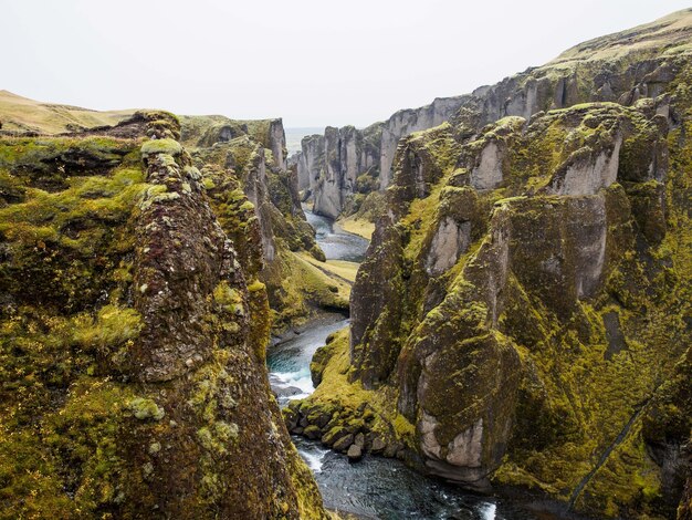 Mesmerizing view of the river flowing down the cliffs under the blue sky