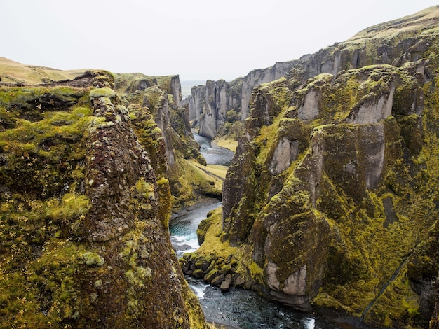 Mesmerizing view of the river flowing down the cliffs under the blue sky