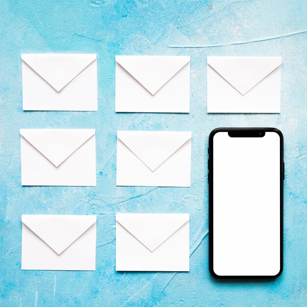 Message icons white paper envelope with cellphone on blue background