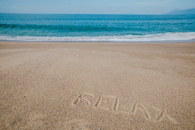 Message on sand saying to relax