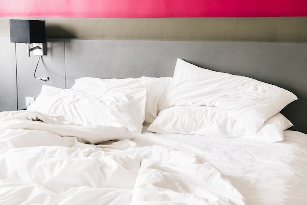 Messy bed with white duvet