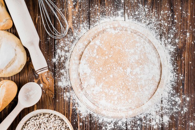 Messy flour on wooden plate over the table