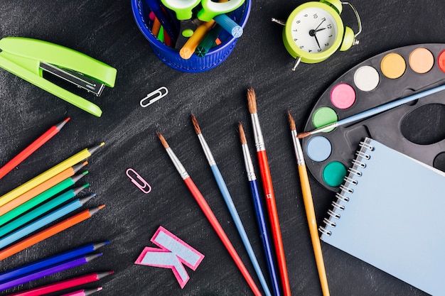 Messy multicoloured stationery for creating art on dark background