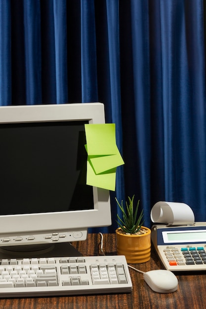 Free photo messy office desk with old computer still life