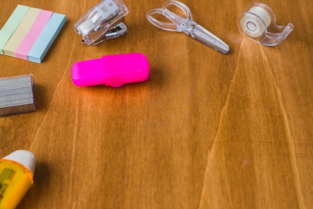 Messy wooden desk with school material