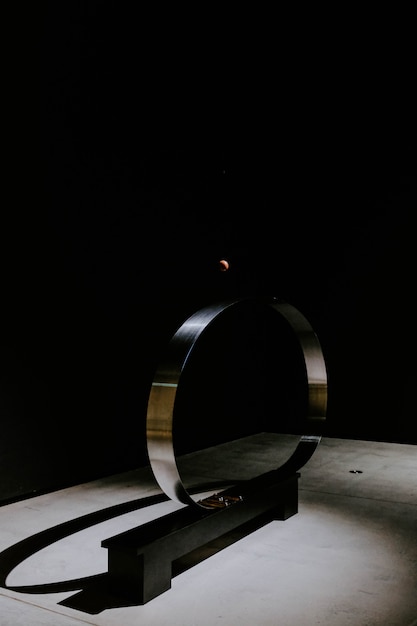 Free photo metal circle in front of a black wall