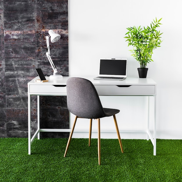 Metal desk with laptop and chair