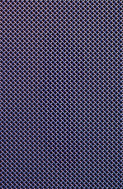 Metal grill closeup texture of a music speaker in colored lighting