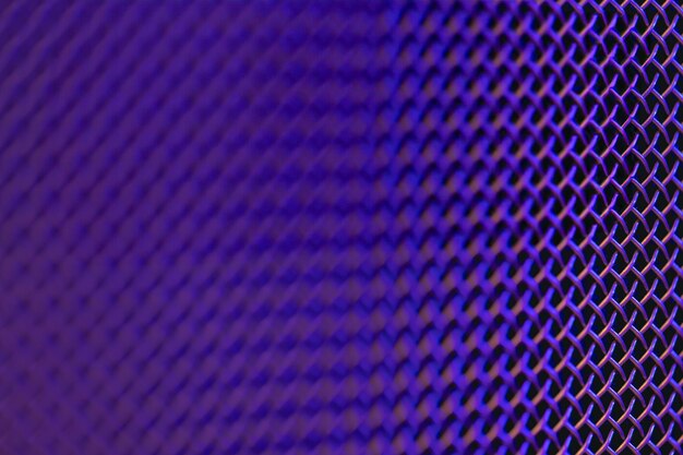 Metal grill closeup texture of a music speaker in colored lighting