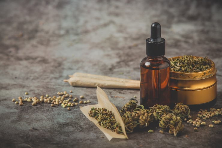 Free Photo metal grinder weed,canabis oil and joint on posing