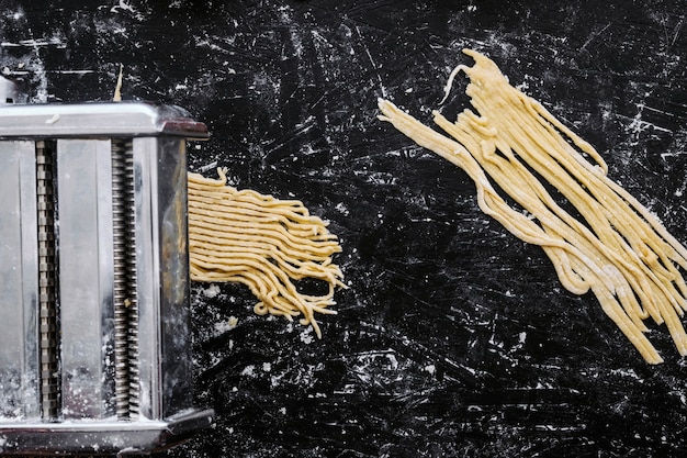 Free photo metal machine preparing pasta