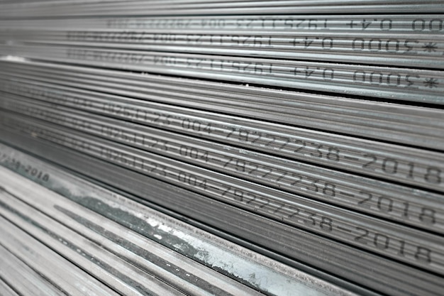 Metal profiles for drywall stacked in stock and ready for delivery to the buyer, selective focus