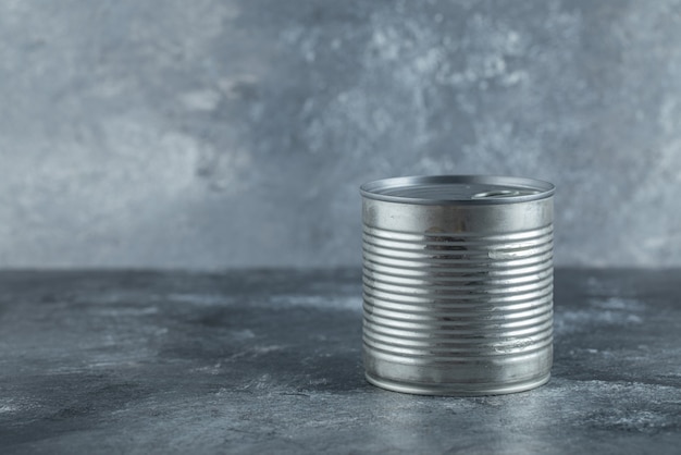 Metal tin can placed on marble.