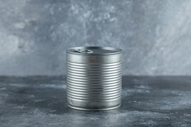 Metal tin can placed on marble.