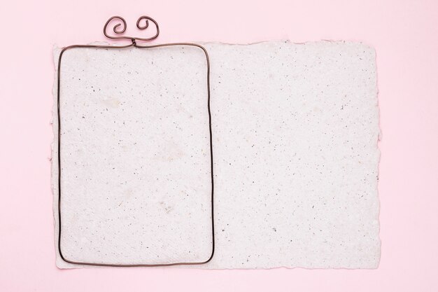 Metallic frame on white texture paper over the pink backdrop