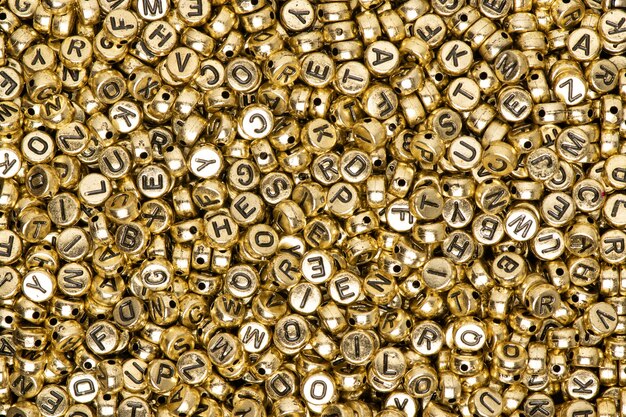 Metallic gold English alphabet beads background