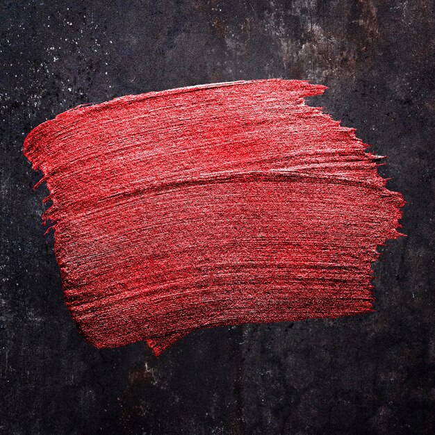 Металлическая красная масляная краска мазок кисти текстуры на черном фоне