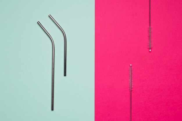 Metallic straws on bicolored background